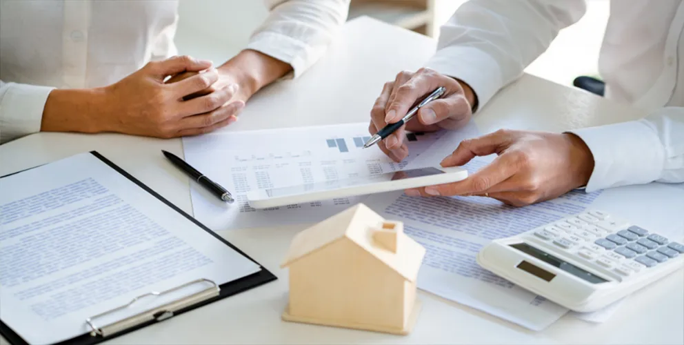 Image of two people doing paperwork on a desk